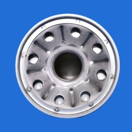 Close-up of a silver car wheel hub with circular holes around a central bore on a blue background.