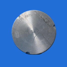 Close-up of a brushed metal circular disc with engraved numbers and letters on a blue background.