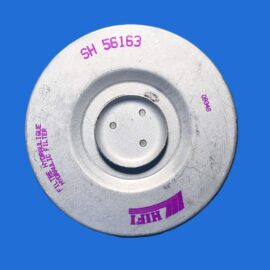 Close-up of a gray circular metal disc with purple stamping against a bright blue background, edge partially cropped.