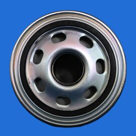 Close-up of a shiny metal car wheel rim with circular holes against a blue background.
