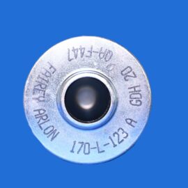 Close-up of a silver metal circular dial/spool with a central hole and engraved alphanumeric markings on a blue background.