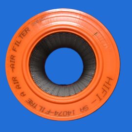 Close-up of an orange rubber tire inner tube with a black textured inner surface, set against a solid blue background.