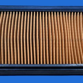 Pleated brown automotive air filter inside a black rectangular housing.