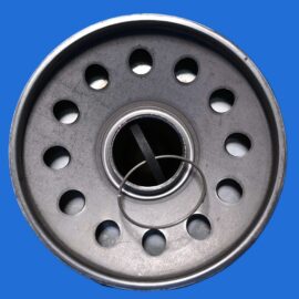 Close-up of a metal circular component with evenly spaced holes around the edge on a blue background.