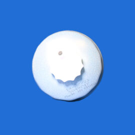 Close-up of a white circular disk with a small central hole, set against a solid blue background.