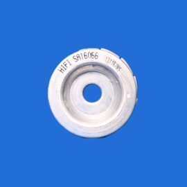 Close-up of a silver circular metal component with a central hole, set against a solid blue background.