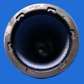 Close-up of a metal circular connector seen from the end, dark inner bore, with a solid blue background and a 'PUR' mark on the rim.