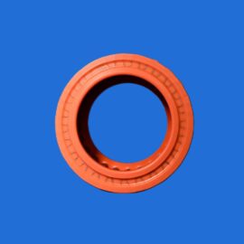 Orange circular rubber gasket on a solid blue background, close-up view.