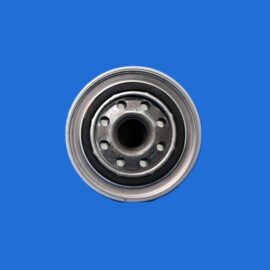 Close-up of a metal can lid with circular ventilation holes against a blue background.