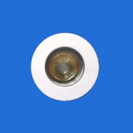 Close-up of a white dome security camera with a glass lens against a solid blue background