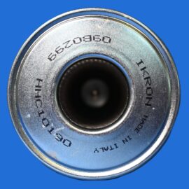 Close-up of a metal combination lock dial on a blue background, showing a circular, grooved surface.