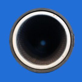 Top-down close-up of a circular metal pipe opening with a dark interior and a blue background behind it.