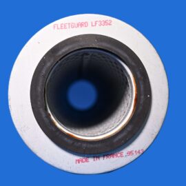 Close-up of a circular metal component with a black inner bore and red text on a white ring, set against a blue background (reads 'FLEETGUARD LF3352').