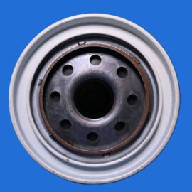 Close-up of a metal wheel hub with multiple circular holes, set against a solid blue background.