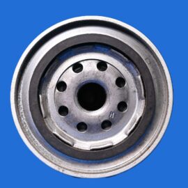 Close-up of a silver car wheel hub with bolt holes against a blue background, showing circular design and central bore.