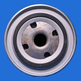 Close-up of a metal pulley wheel with rust on the inner surface, against a solid blue background.