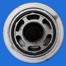 Close-up of a metal bearing with a black inner ring against a solid blue background.