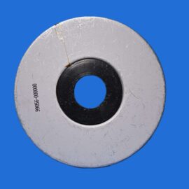Close-up of a scratched gray metal washer with a black inner bore on a blue background.